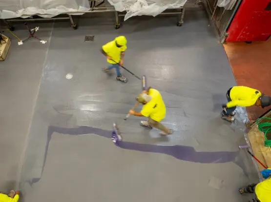 Workers applying floor coating with no business interruption